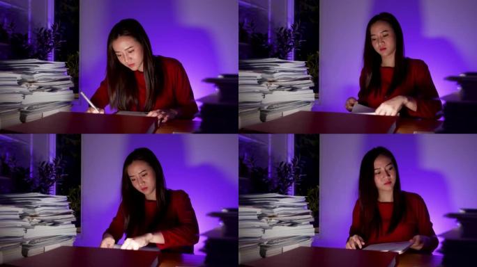 办公桌上疲惫的女商人加班做截止日期项目，迟到的生意。