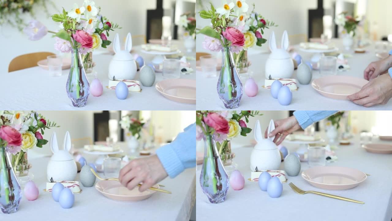 一个女人的手的特写镜头，为复活节做一个现代的餐桌布置
女人的手为复活节做现代餐桌装饰的特写