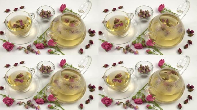 茶壶和杯子配粉红玫瑰花蕾花茶