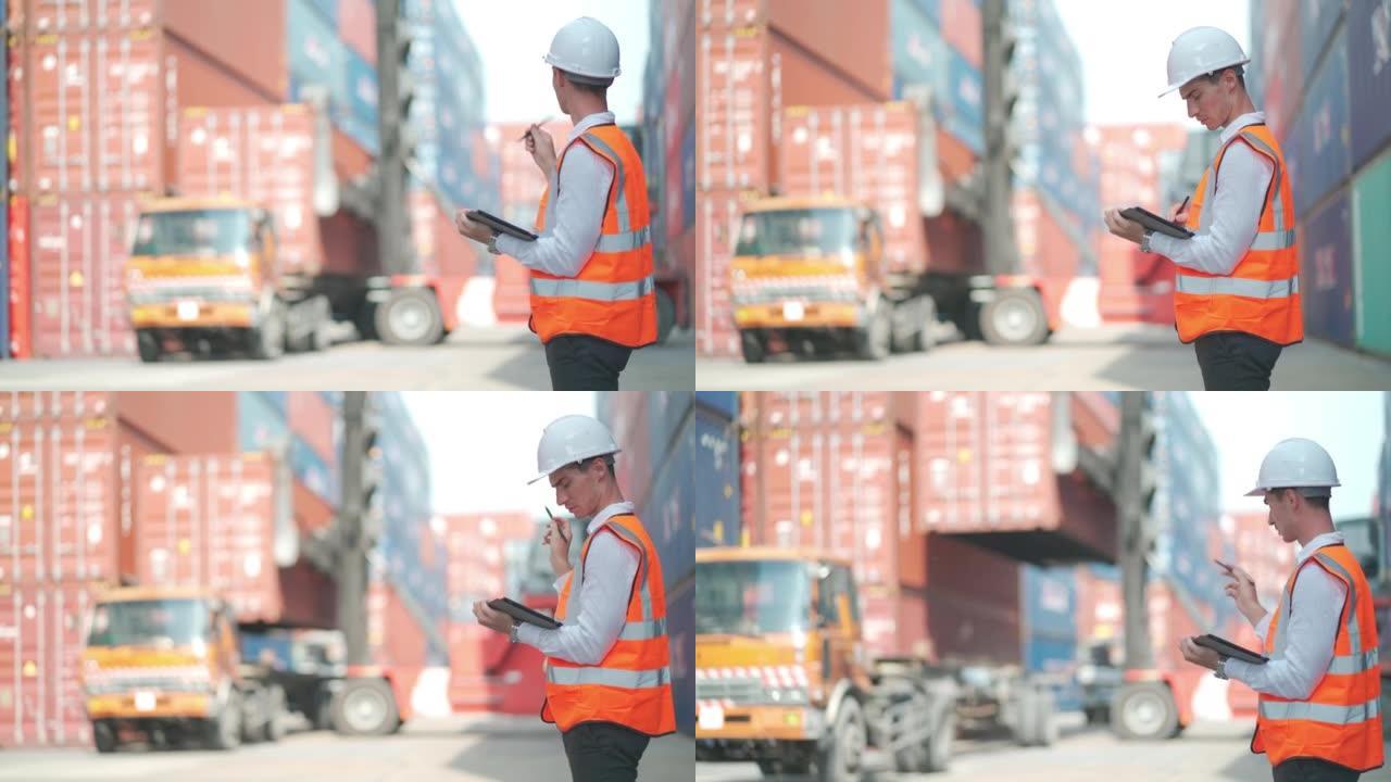 货物集装箱工人用平板电脑检查和监控进出口运输，卡车在后台工作
