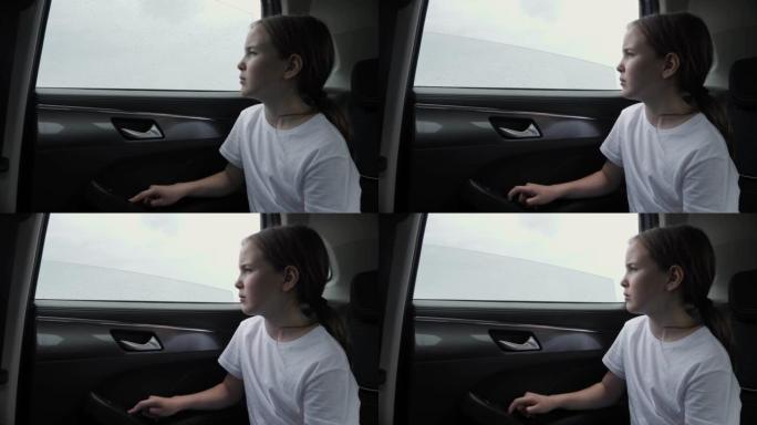 无聊的女孩玩车窗升降玻璃