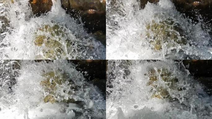 水晶清澈的山水在慢动作中坠落在岩石上