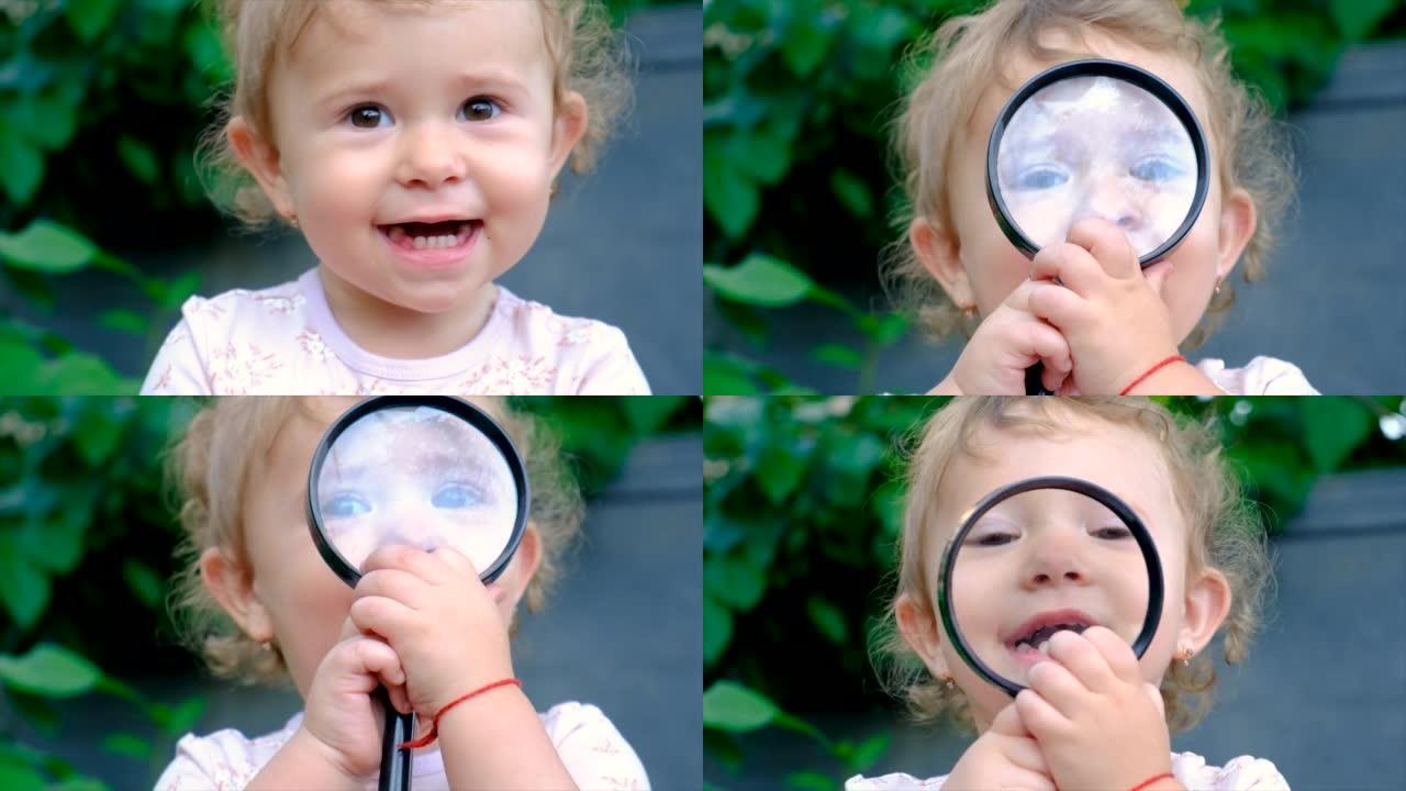 孩子用放大镜探索大自然。选择性聚焦。自然。