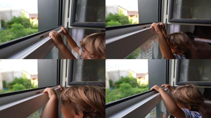 孩子抱着窗户危险的小男孩在窗户附近想看到外面的家庭事故
