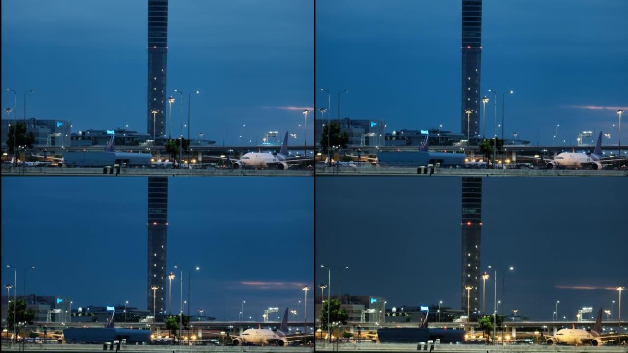 2022年7月11日，曼谷，飞机在素万那普国际机场跑道和机场旁边的公路上起降，夜间汽车运送乘客。在泰