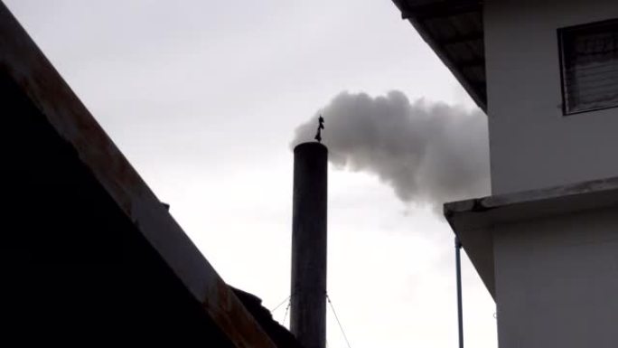 烟雾从烟囱燃烧到工厂的天空