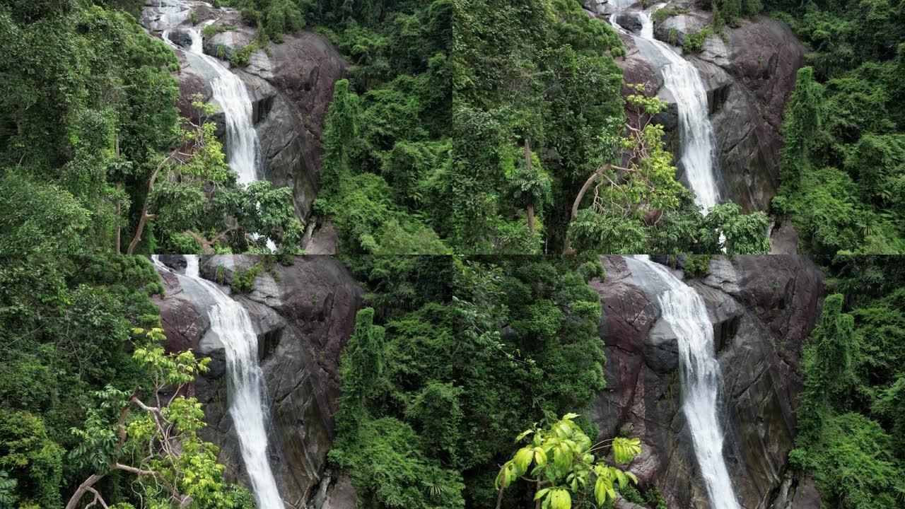 在马来西亚吉打州兰卡威的Telaga Tujuh瀑布中穿越热带森林的树叶。空中无人机射击