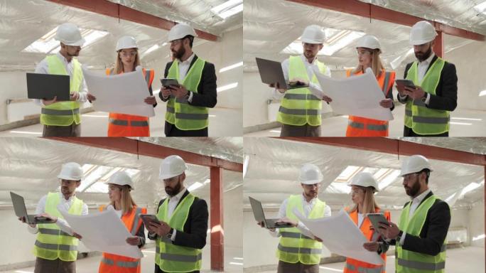 专家团队在建筑工地使用笔记本电脑平板电脑蓝图。房地产空楼项目与土木工程师，建筑师，商业投资者和一般工
