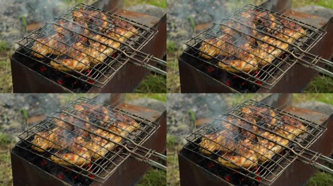 火盆上金属烧烤中的鸡翅特写