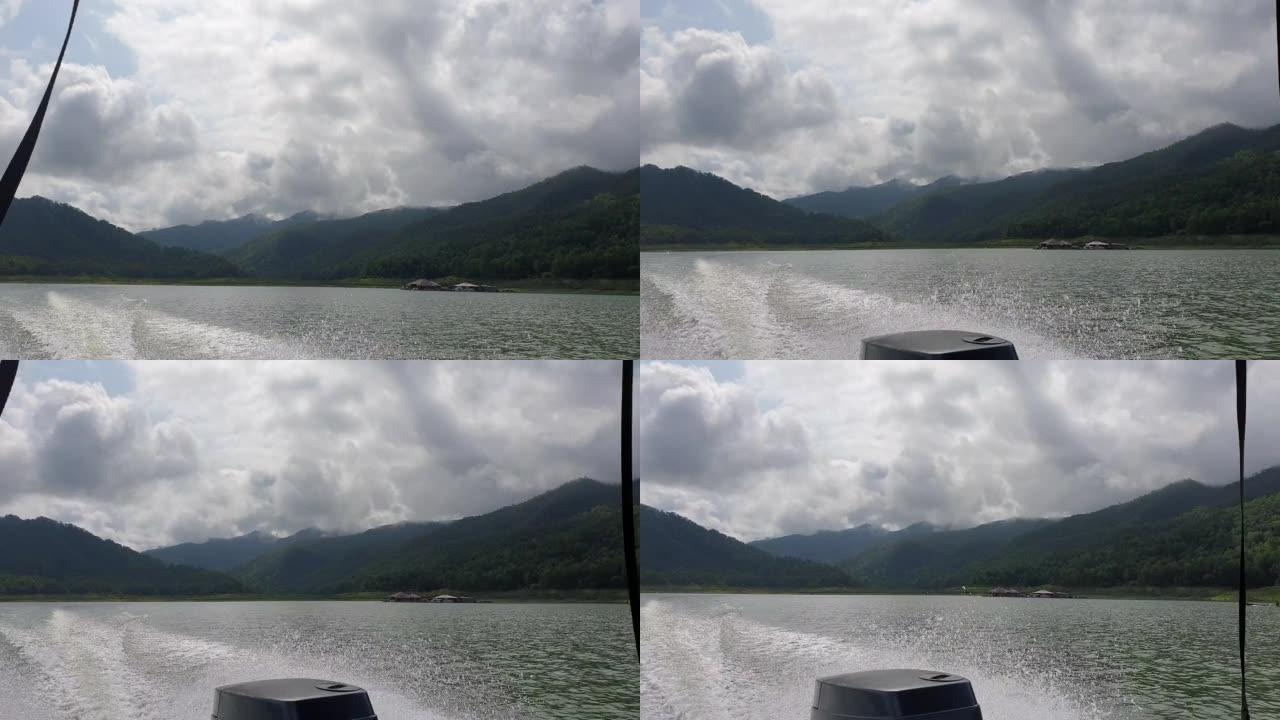 快艇马达的观点巡航通过湖坝山漂浮