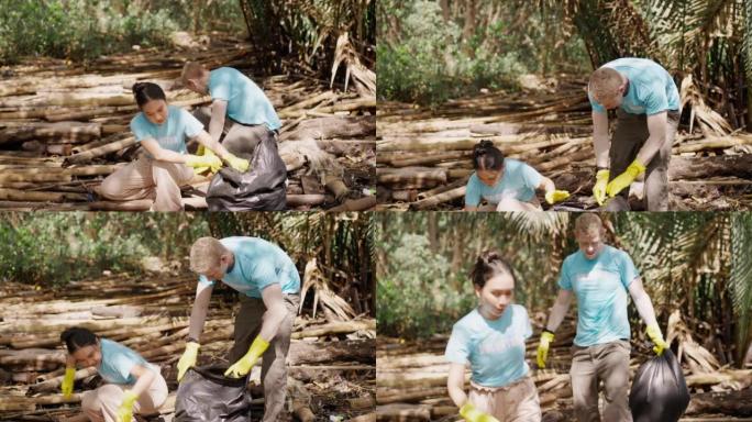 高加索人和亚洲年轻的成年志愿者，戴着黄色橡胶手套，一起帮助将垃圾和塑料袋收集到垃圾袋中，并在一切几乎