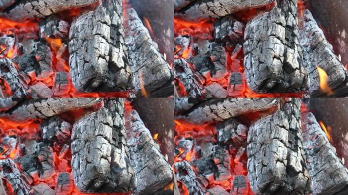 闷烧的煤，火热的背景橙色火焰燃烧。燃烧时发出劈啪作响的木头声音的火灾危险视频