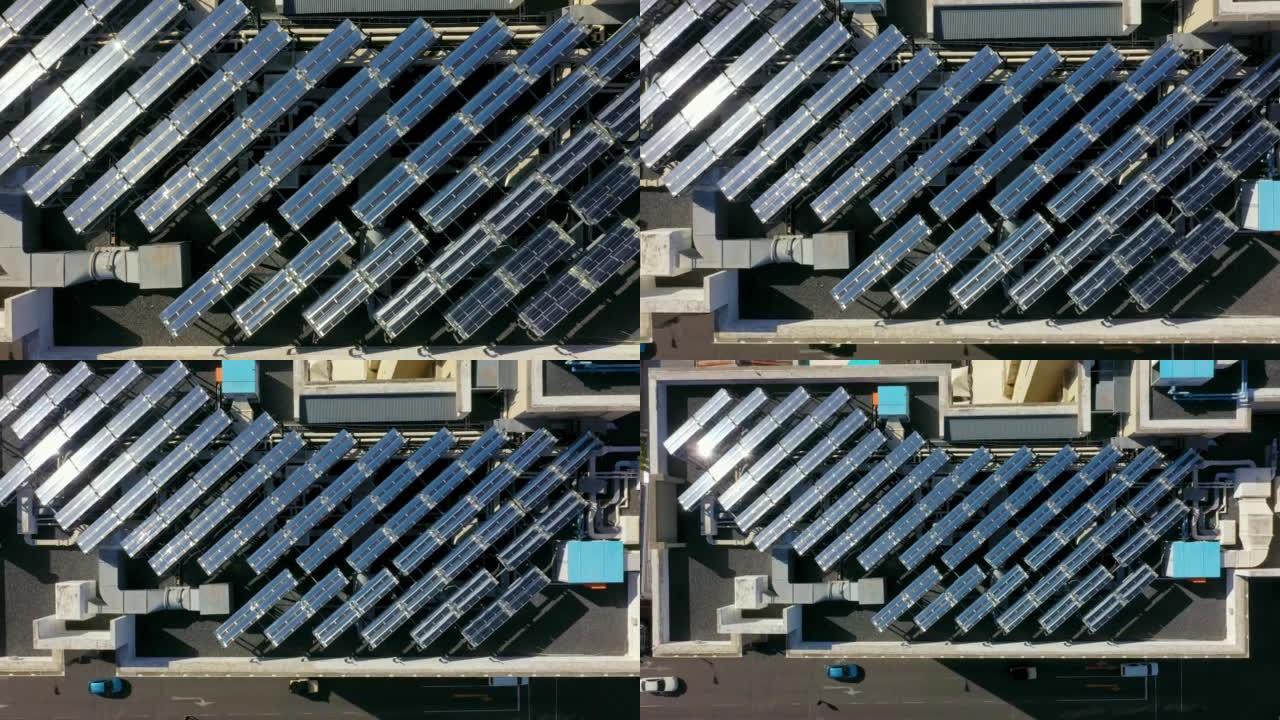 许多太阳能电池板安装在高层建筑的平屋顶上，吸收阳光以产生可持续的电力。一排节能光伏组件，在开普敦市区