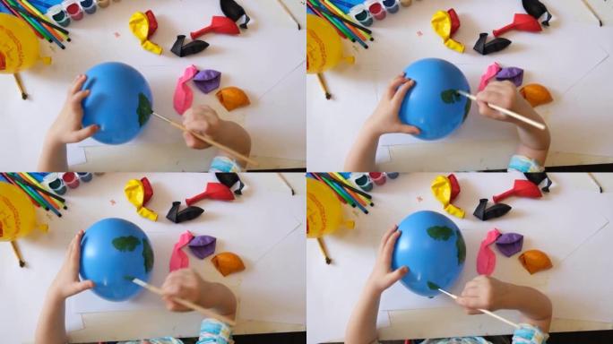 用气球为地球日做地球的孩子。用绿色大陆画蓝色球。