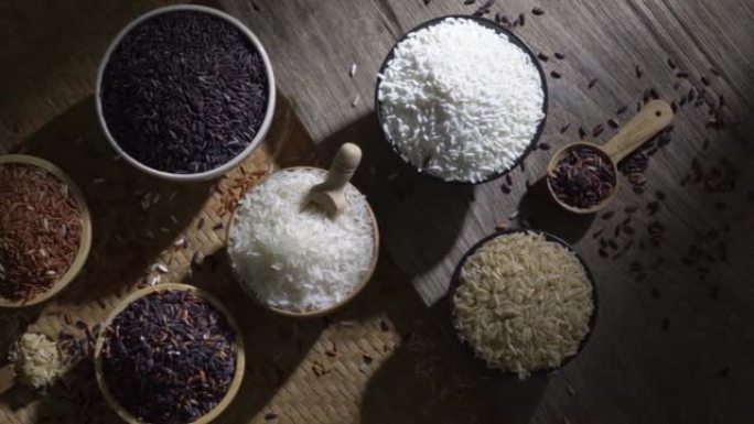 有机糙米和亚洲黑米饭，木桌碗中的茉莉白米饭，有机天然食品概念的未煮熟产品，顶视图
