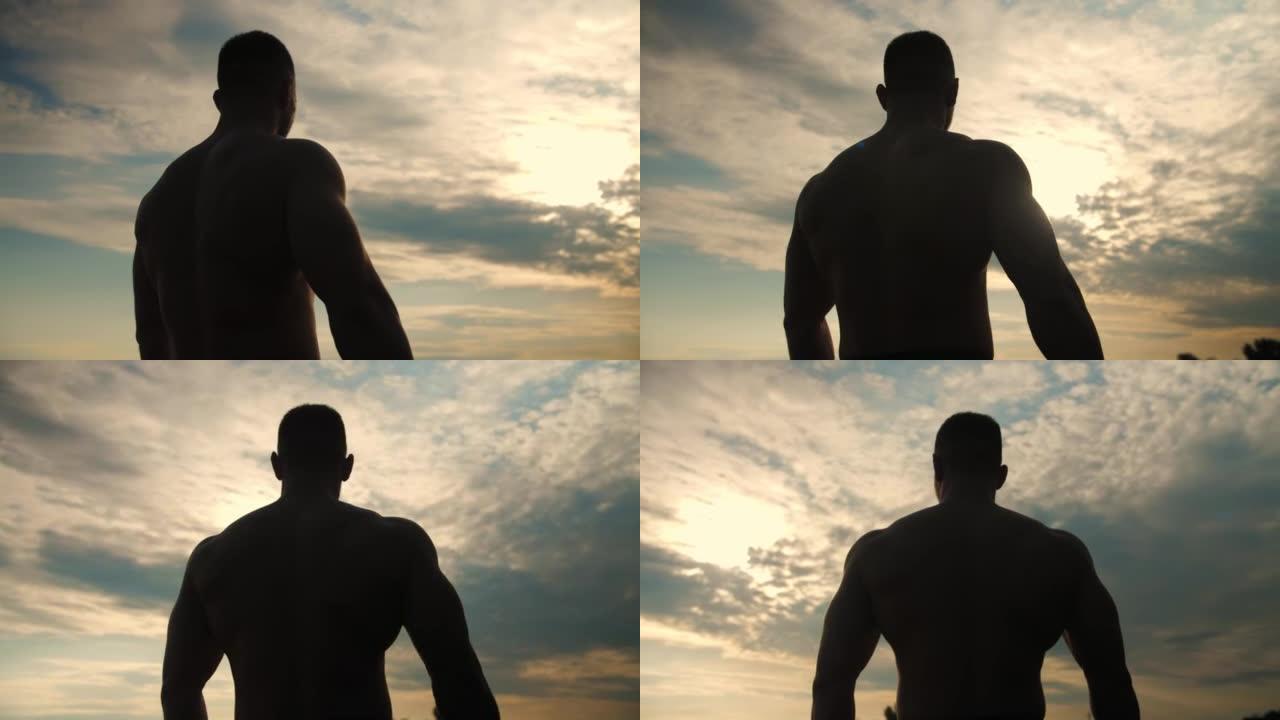 身体赤裸的人，在海滩上看日落。轨道拍摄。慢动作