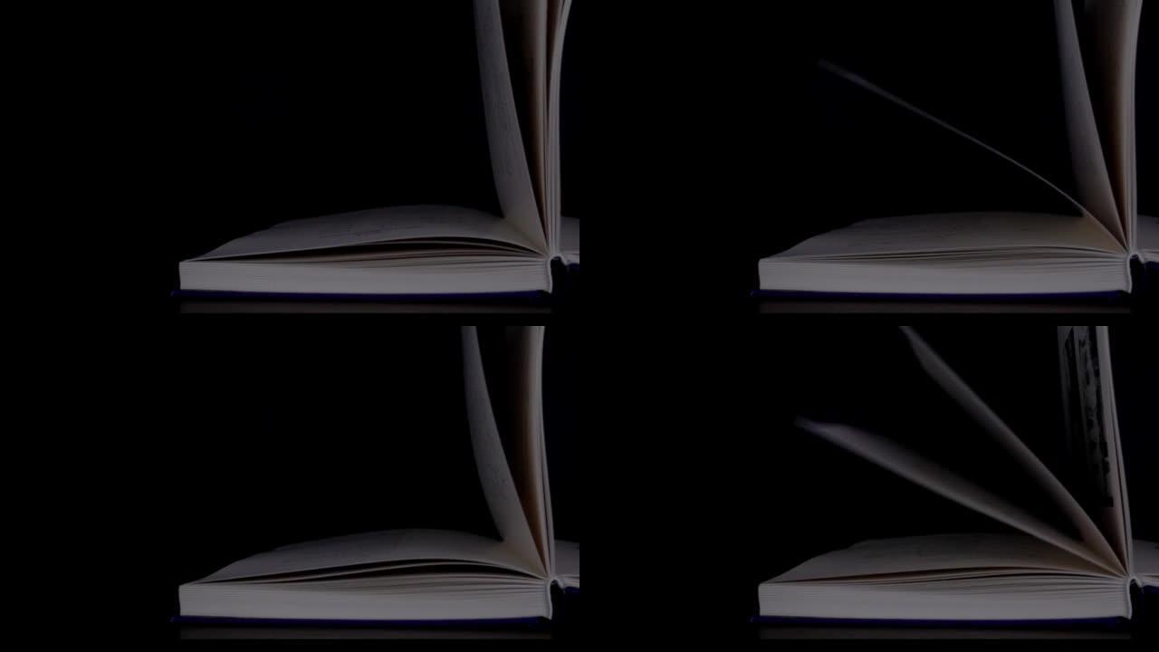 书页的慢动作视频镜头在黑色背景上打开，带有复制空间。