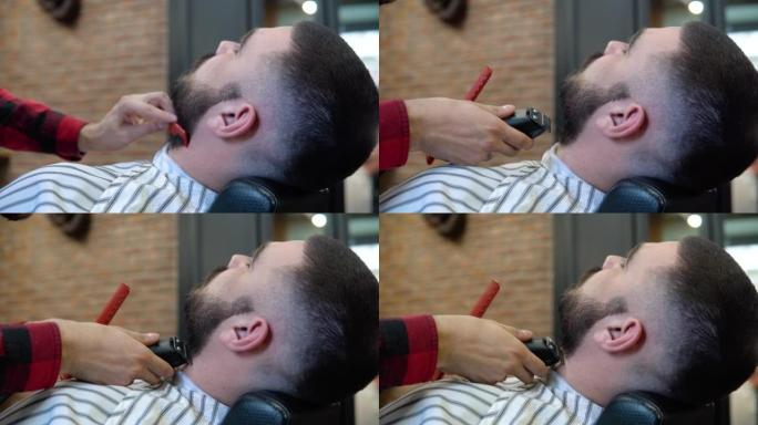 客户坐在理发店的椅子上，一边剪胡须。精英男士理发店