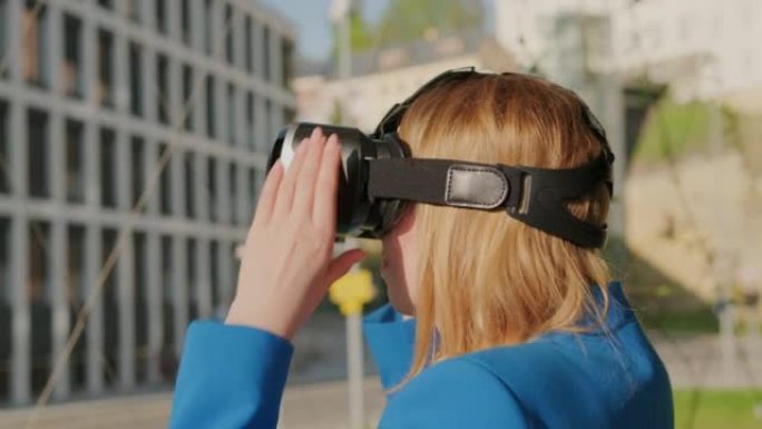 女人戴着虚拟现实耳机开始使用虚拟界面