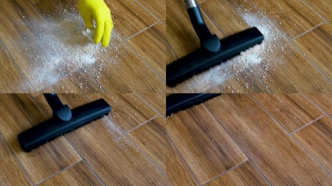 清除地板上溢出的散装混合物。一个人用吸尘器打扫地砖。