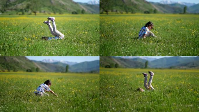 小女孩在草坪上翻筋斗