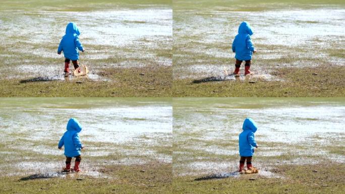 在草地上玩泥水的可爱男孩