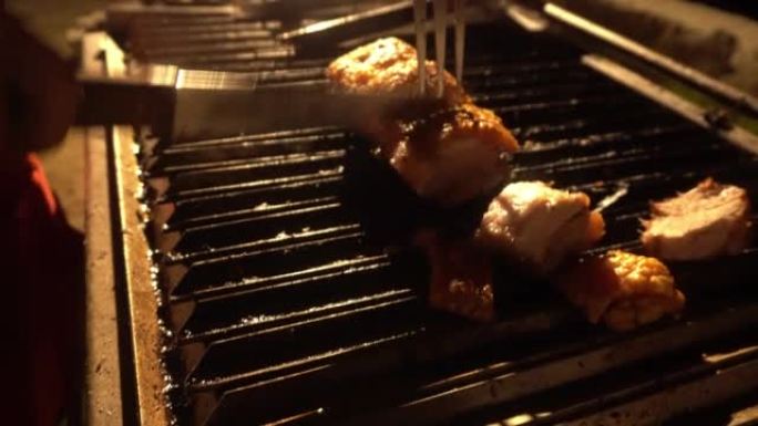特写镜头用刀将猪肉切成中国盒子，用刀将手放在烤架上