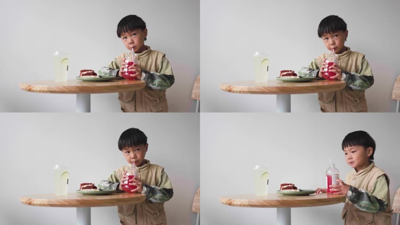 亚洲男孩在咖啡店喝苏打水