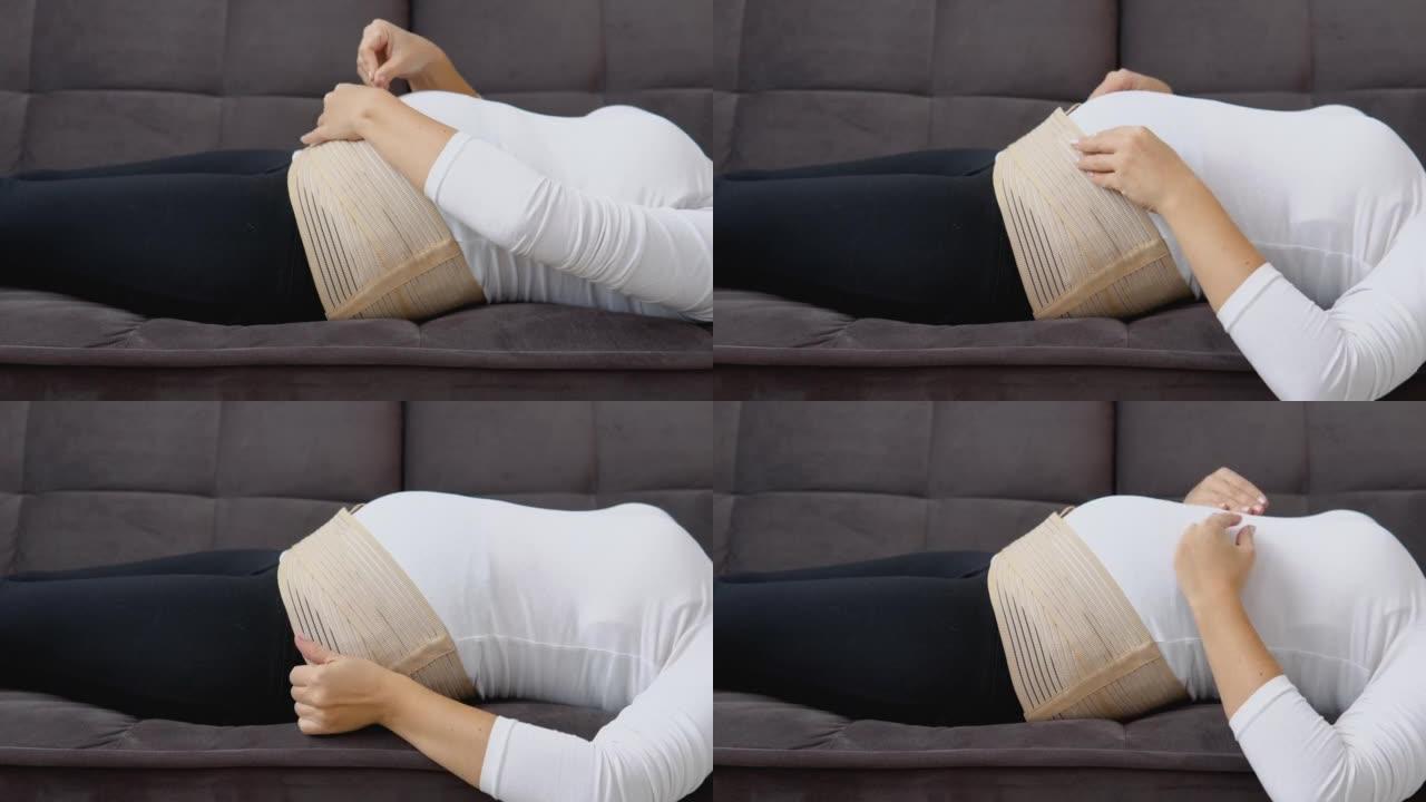 仰卧位皮肤白皙的孕妇根据使用说明为孕妇穿绷带