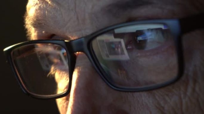 一位戴着电脑眼镜的商人聚焦眼睛的特写