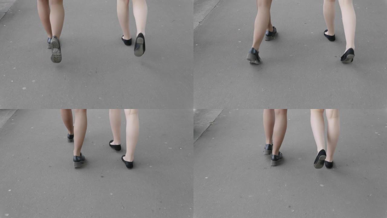 Two girls are walking along the street. Video Ultr