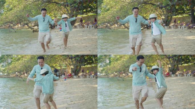 海滩上快乐的亚洲家庭。父亲和小儿子手牵在一起，早上在海岸线上奔跑和玩耍。可爱的孩子儿子和爸爸在户外暑