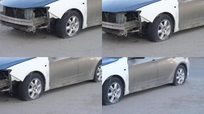 客车在沥青路面上站着干轮。车祸后汽车轮胎被刺破。盗窃和意外事故的汽车保险