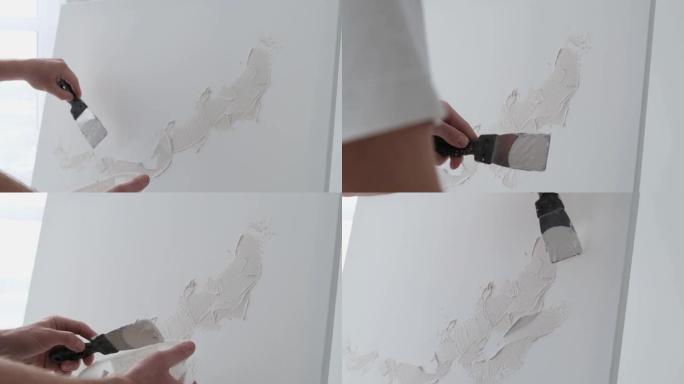 一位年轻的艺术家在干净的白色画布上画白色油漆