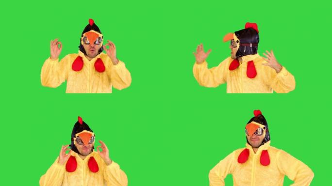 机智的艺术家穿着小鸡服装，在绿色屏幕上做了一些手势，颜色键，表达了非常情绪化的东西