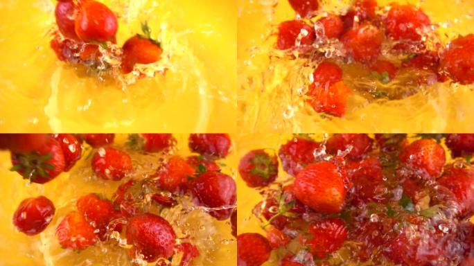 将草莓倒入橙色背景的玻璃碗中的水中。慢动作。