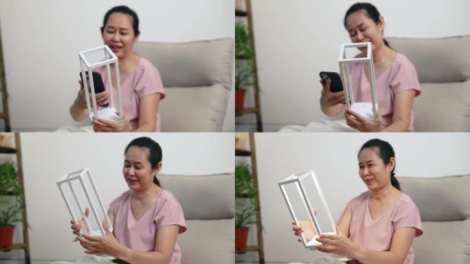 资深亚洲女性在网上购买的新灯的照片和照片。