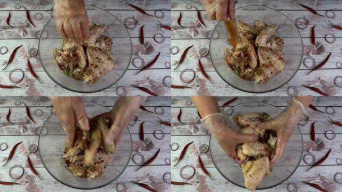 厨师撒上香料，将生的翅膀倒入装有腌料的玻璃碗中，然后用手混合。