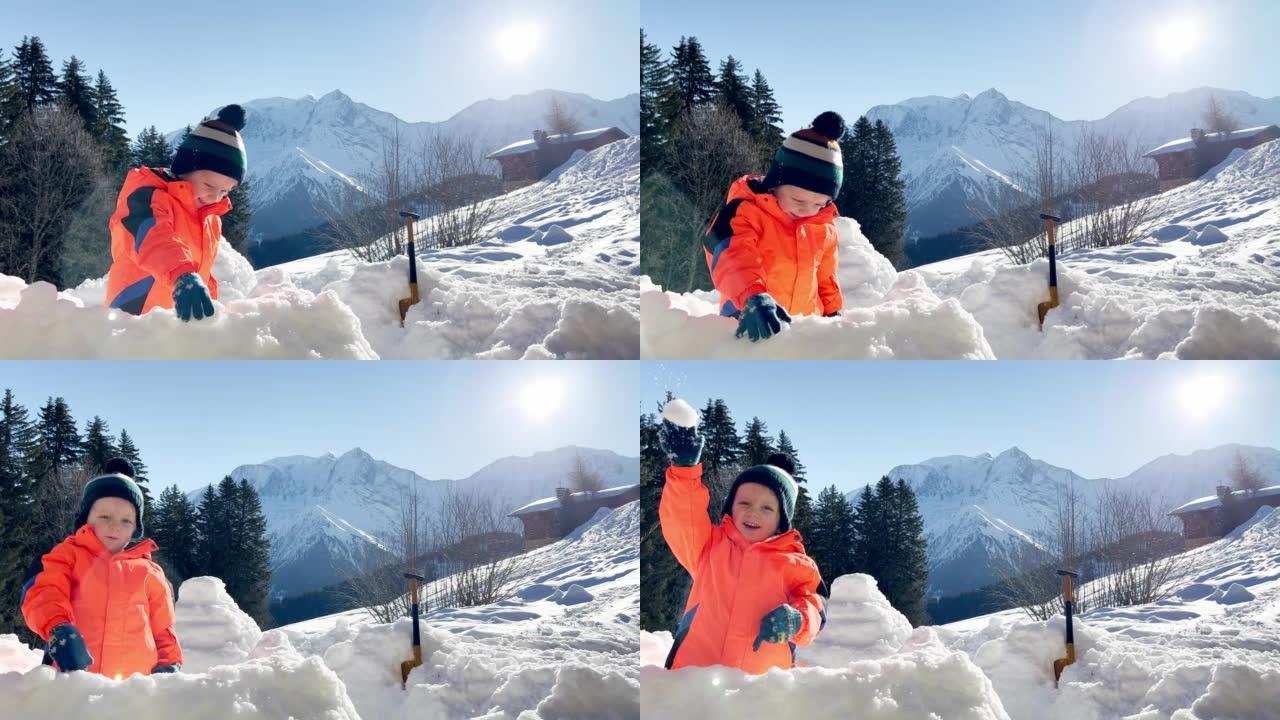 男孩扔雪球站在山上的雪堡垒中
