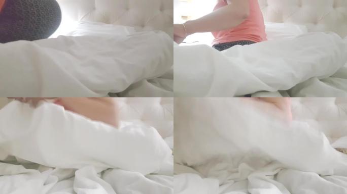 4在视频中，一个穿着睡衣的女人晚上上床睡觉，用白色毯子盖住自己，卧室的内部有床和台灯