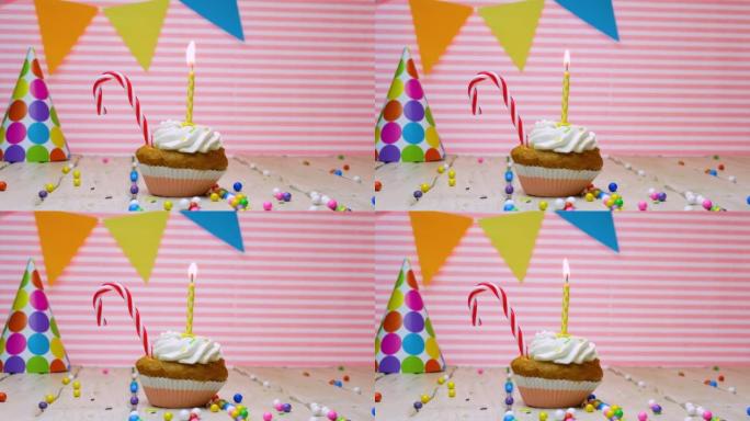 任何年龄的生日祝福，拷贝空间，美丽的视频背景快乐的生日粉红色的背景奶油纸杯蛋糕和蜡烛与火