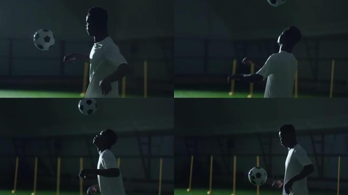 职业足球运动员在训练中心踢足球，非洲男子在运动中的肖像