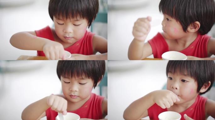 Asian boy eating ice cream at the cafeteria