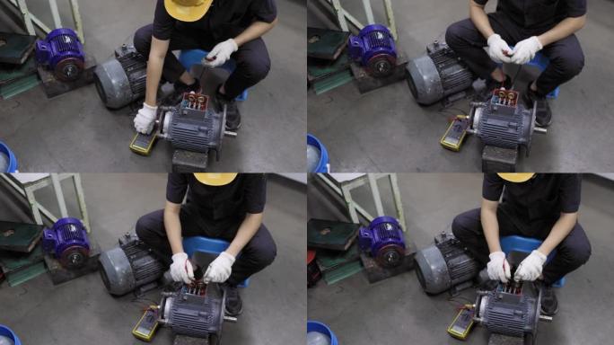 一位年轻的工程师正在用万用表检查电动机的绕组电阻。