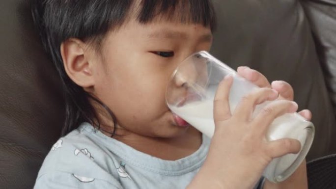 Little boy drinking a glass of milk.