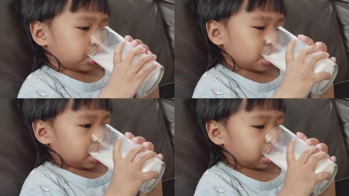 Little boy drinking a glass of milk.