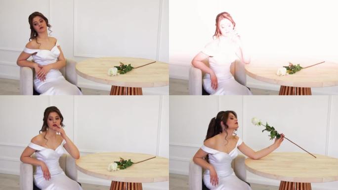 一个漂亮的女孩摆姿势坐在桌旁，拍了一朵白玫瑰。