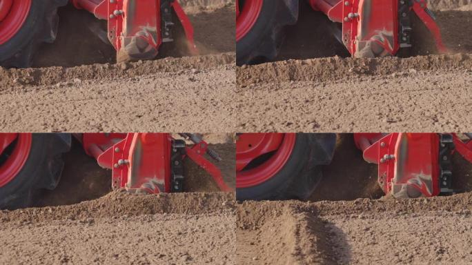拖拉机在农场用旋耕机耕种土地，慢动作。
