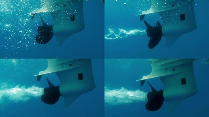 船螺旋桨在水下旋转的慢动作海底视图，从发动机产生气泡螺旋轨迹