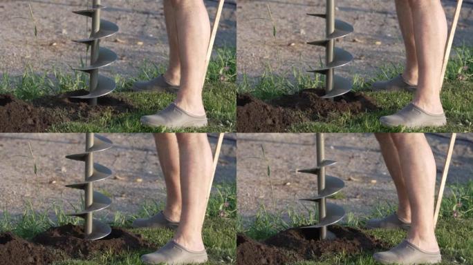男子使用工具手持便携式手动土石钻为植树准备土壤